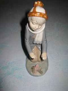 zaphir porcelain figurine boy warming hands over fire time left