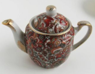 Royal Paisley, small tea pot, 4H with cover. It is gold sponged 