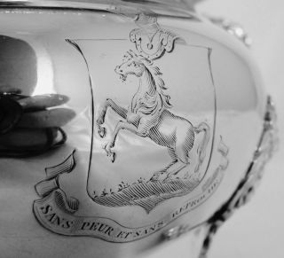 PRESENTED IS AN ELABORATELY CRAFTED SOLID SILVER SAUCE TUREEN CREATED 