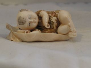 Antique Signed Netsuke of Child Sleeping on a Leaf both pieces are