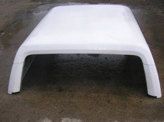 Very nice condition. No cracks. This is the fiberglass rear top that