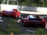 Two Ferraris playing follow the leader around a tight turn in Gran
