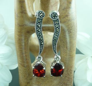 elegant silver and garnet long drop earrings featuring striking inset
