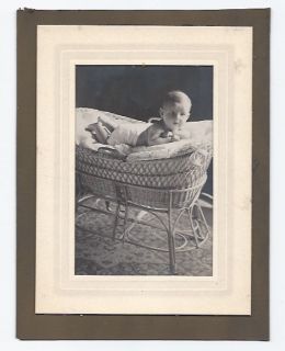 1913 photograph baby in wicker bassinet.